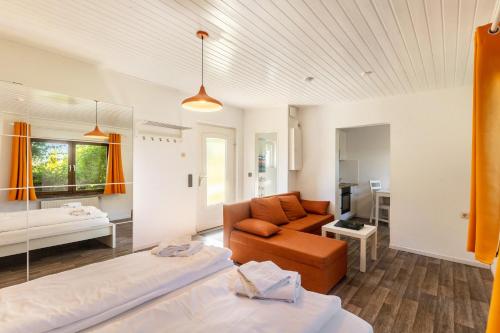 a living room with two beds and a couch at db Staycation Ferienpark in Niedenstein