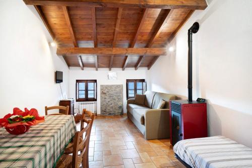 a living room with a table and a couch at Casa Verde - Sciu´ Pepin in Rezzo