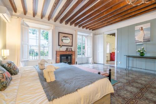 a bedroom with a large bed and a fireplace at Moli dels Reis in Palma de Mallorca