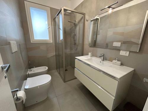 a bathroom with a toilet and a sink and a shower at Lungomare Santa Caterina in Nardò