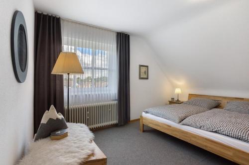 a bedroom with a bed and a large window at Ferienwohnung Riedel in Sundern