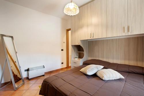 a bedroom with a large bed with two pillows on it at La Casa Di Pasky in Roisan