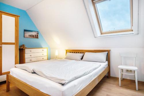 a bedroom with a large bed with a window at Kranich in Pruchten