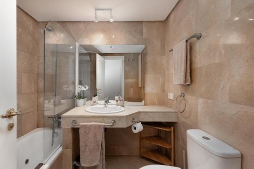 a bathroom with a sink and a shower and a toilet at Apartment Coto Real in Manilva