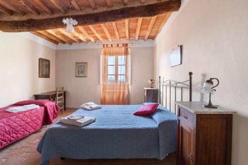 a bedroom with two beds and a window at Villa Chelucci - Gualdo in Massarosa