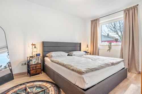 a bedroom with a large bed and a window at Haus Gertrud in Wiek auf Rügen