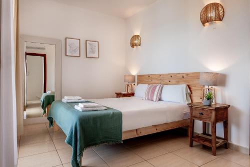 a bedroom with a bed and a table with a night stand at Ca na Magdalena in Santanyi