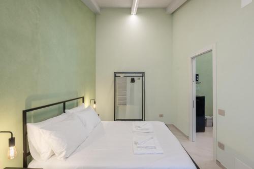 a bedroom with a large white bed with white pillows at Dimora Storica Lucia in Ascea