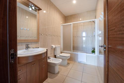 a bathroom with a toilet and a sink and a shower at Ca na Magdalena in Santanyi