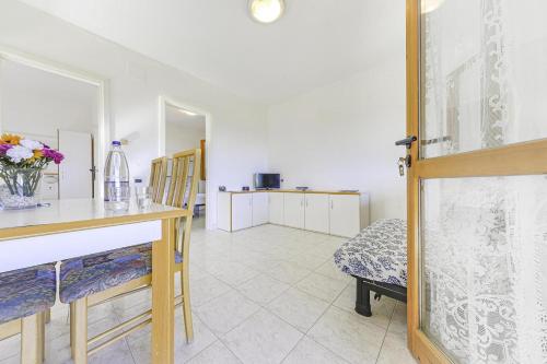 a room with a table and chairs and a kitchen at Villaggio Colombo V6 in Marina di Andora