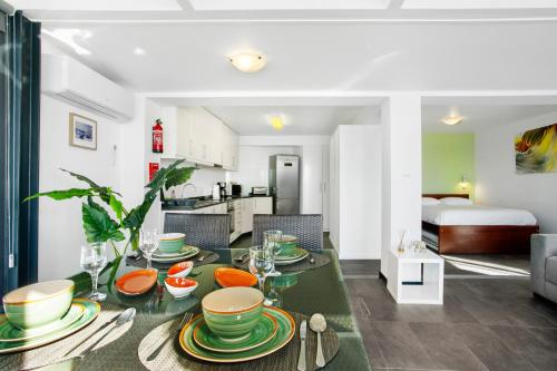a dining room and living room with a table and chairs at The Wave House - Seaside Haven in Jardim do Mar