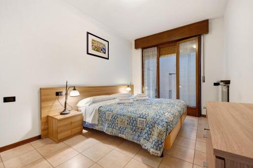 a hotel room with a bed and a window at Appartamento Assenza 9 in Brenzone sul Garda