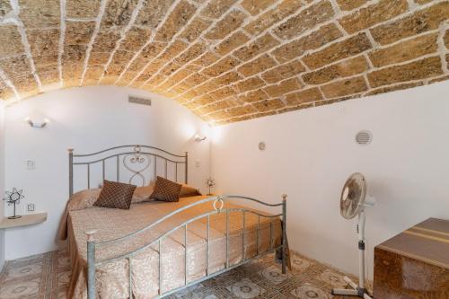 a bedroom with a bed and a brick ceiling at Elena Inn in Matino