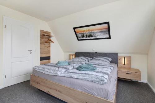a bedroom with a bed with blue towels on it at Ferienhaus Pfanne in Hennstedt