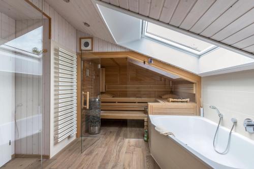a bathroom with a bath tub and a window at Ferienhaus Manni Dg in Büsum