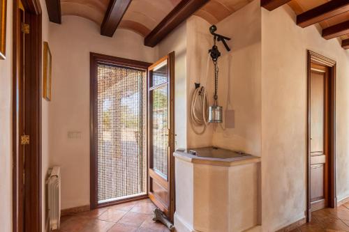 a hallway with a large window and a sink in a room at Finca Es Turo in Santanyi