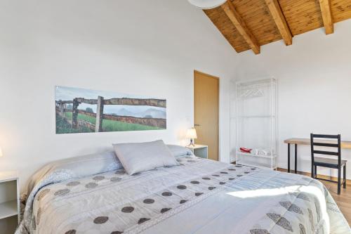a bedroom with a bed and a table with a chair at Picuastur in Cangas de Onís