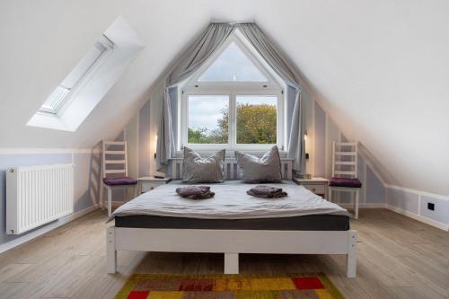 a bedroom with a bed with a large window at Bäckerhus - Ferienwohnung 4 in Wiek auf Rügen