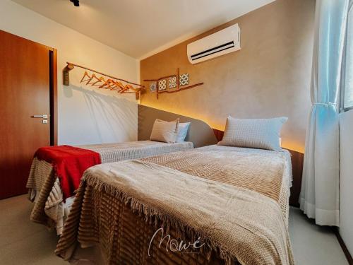 a room with two beds in a room at Apartamento Verano pé na areia em tatuamunha - NSUN105 in Pôrto de Pedras