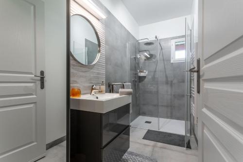 a bathroom with a sink and a mirror at Pomme Reinette in Le Val