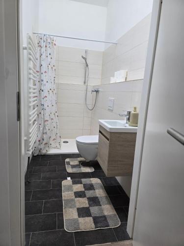 a bathroom with a toilet and a sink at La petite ferme de Fine in Burg bei Magdeburg