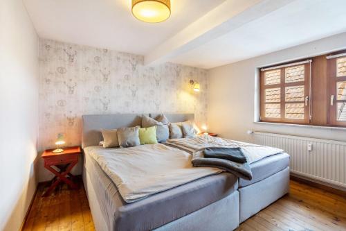 a bedroom with a large bed and a window at You R Welcome too in Frischborn