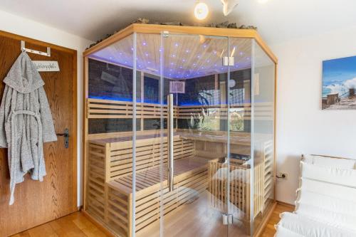 a large glass enclosure in a room at You R Welcome too in Frischborn
