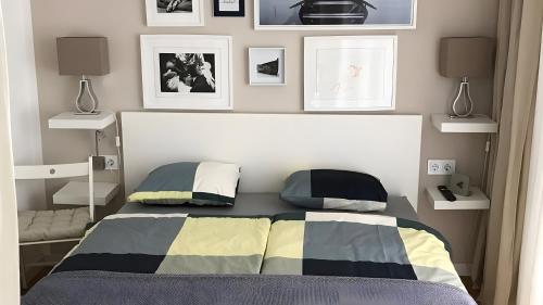 a bedroom with a bed and pictures on the wall at Ferienwohnung Lichtblick in Sattendorf