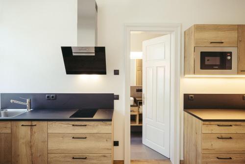 a kitchen with a sink and a microwave at Freienfeldhof Pink Lady in Lagundo