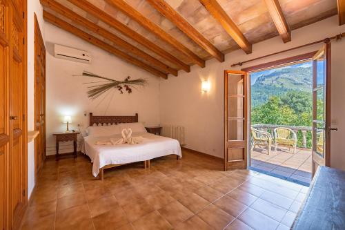 a bedroom with a bed and a large window at Villa La Plana in Pollença
