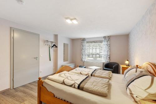 a bedroom with two beds and a window at Ferienwohnung Christel in Schmallenberg