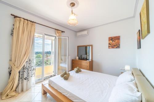 a bedroom with a bed and a large window at Panorama House Petritis in Petrití