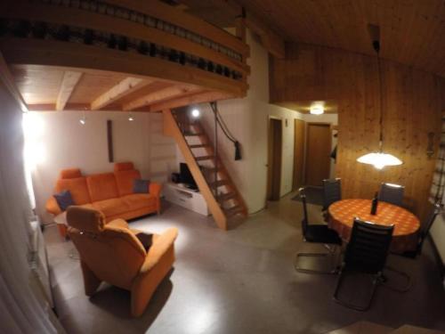 a living room with a couch and a table at Apartment Chalet Steinbock by Interhome in Lenk