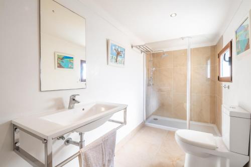 a bathroom with a sink and a toilet and a shower at Can Vidal in Campanet