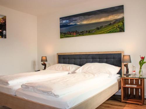 a bedroom with two beds and a painting on the wall at Apartment Hirschen Erlinsbach by Interhome in Erlinsbach