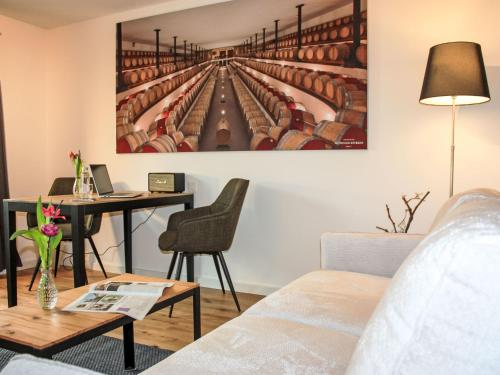 a living room with a table and a painting on the wall at Apartment Hirschen Erlinsbach by Interhome in Erlinsbach