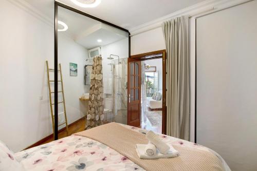 a bedroom with a bed and a glass shower at Carmelo y Carmela 2 in Teror