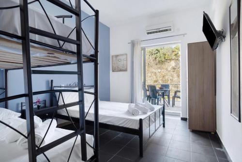 a bedroom with two bunk beds and a balcony at Iguana studio 9 in Preveza