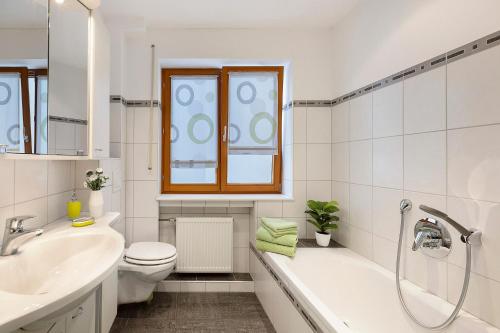 a bathroom with a tub and a toilet and a sink at Rinderle in Stockach