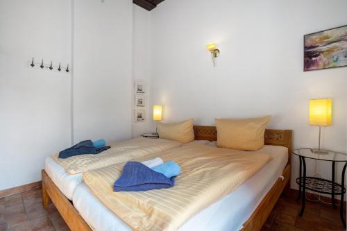a bedroom with a bed with blue towels on it at Traumschlößchen 100 m vom Strand in Heringsdorf