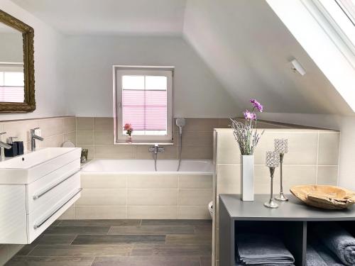 a bathroom with a sink and a bath tub at Haus Silberberg in Haslach im Kinzigtal