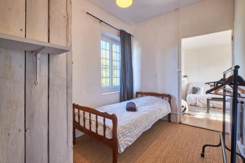 a small bedroom with a bed and a mirror at Location Au Pied Du Vercors in Vinay
