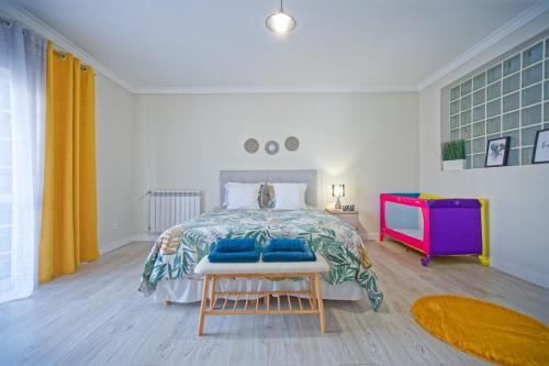 a bedroom with a bed with blue pillows on it at Villa As Cumadres in Azeitao