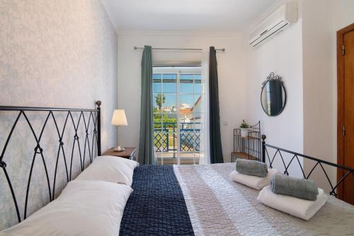 a bedroom with a bed and a balcony at Villa Constança in Manta Rota