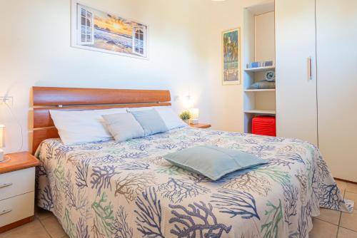 a bedroom with a bed with two pillows on it at Appartamenti Le Querce App. Melograno in Capoliveri