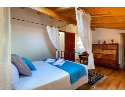 a bedroom with a bed with two towels on it at Ria Sweet Home Paxos in Oziás