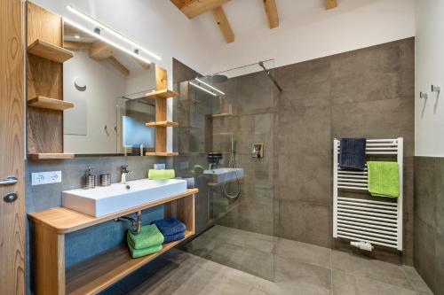 a bathroom with a sink and a shower at Parliflhof Apt Laugenblick in Meltina