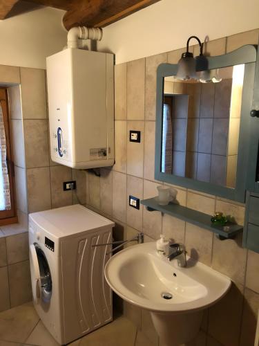 a bathroom with a sink and a mirror at Casa D'Ambros - Cadore in Santo Stefano di Cadore