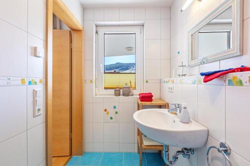 a bathroom with a sink and a window at Ferienwohnung Bergahorn in Todtnauberg