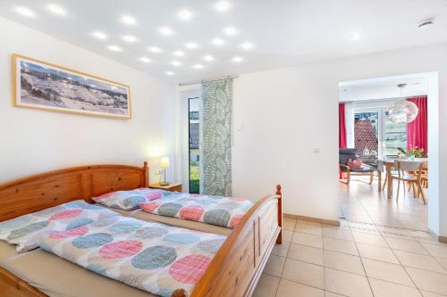 a bedroom with a bed and a dining room at Ferienwohnung Bergahorn in Todtnauberg